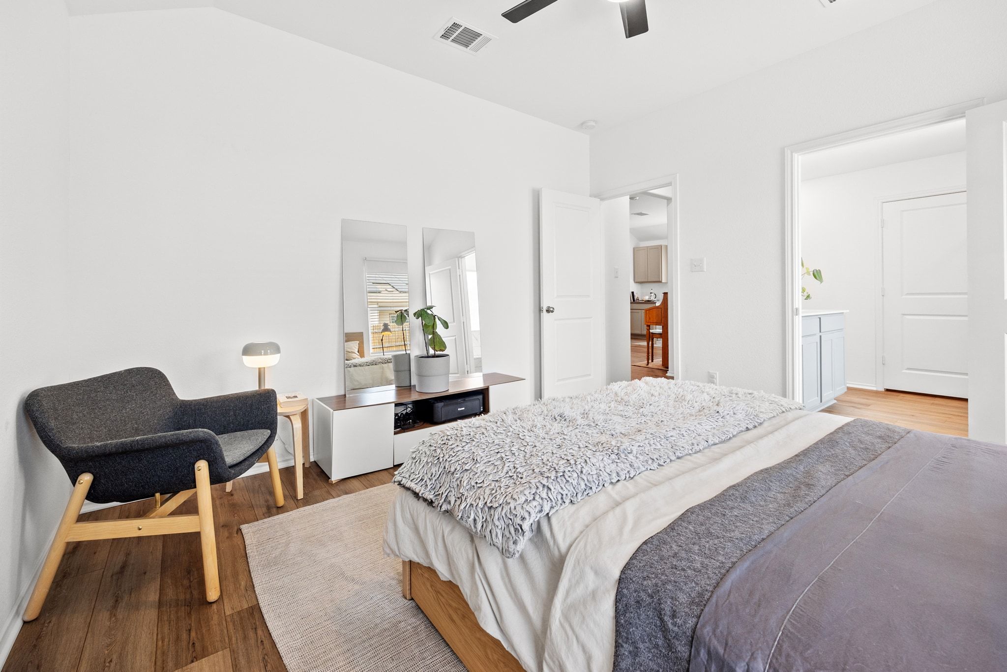 124 Perfect World Loop Jarrell, TX 76537 - Photo 17 of 32 a bedroom with bed and wooden floor