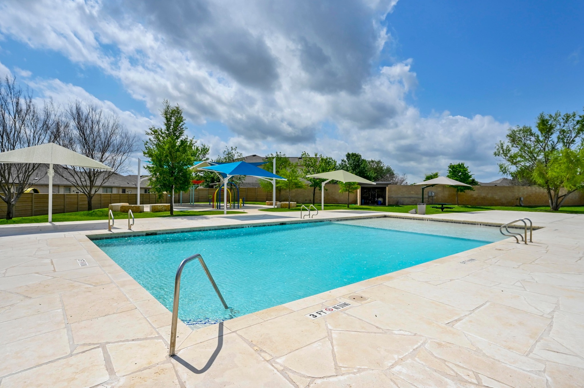 124 Perfect World Loop Jarrell, TX 76537 - Photo 29 of 32 a view of swimming pool that has lawn chairs under an umbrella