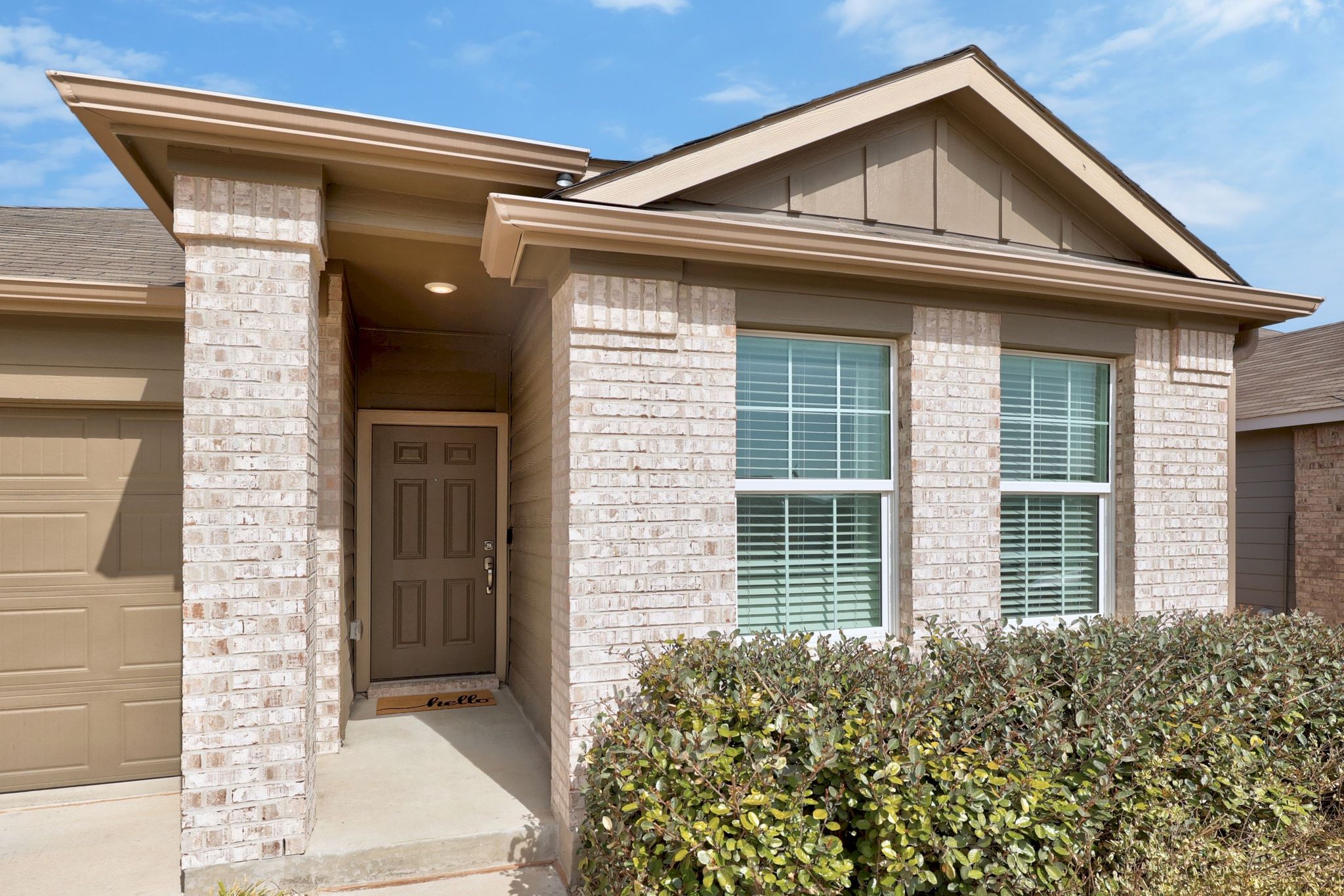 124 Perfect World Loop Jarrell, TX 76537 - Photo 6 of 32 a front view of a house with a garden