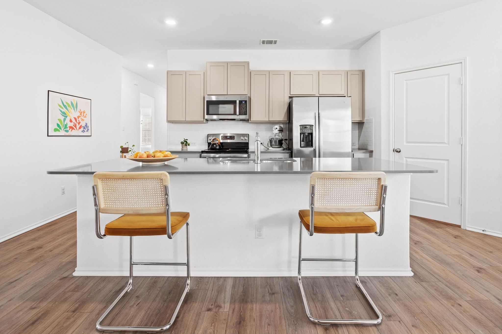 124 Perfect World Loop Jarrell, TX 76537 - Photo 10 of 32 a kitchen with stainless steel appliances a dining table chairs microwave and sink