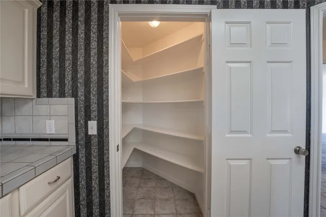 an empty room with windows and entrance