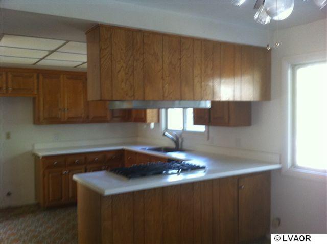 1220 Onstott Road Lompoc, CA 93436 - Photo 3 of 5 a kitchen with a sink cabinets and a window