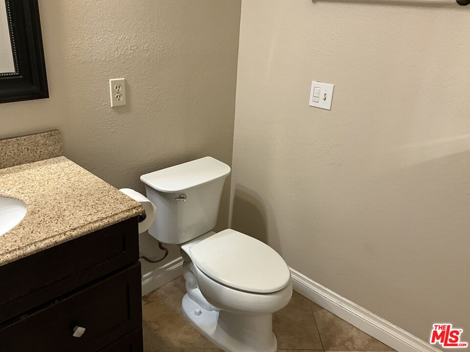 19125 Ottawa Road Apple Valley, CA 92308 - Photo 12 of 15 a white toilet sitting next to a bathroom sink