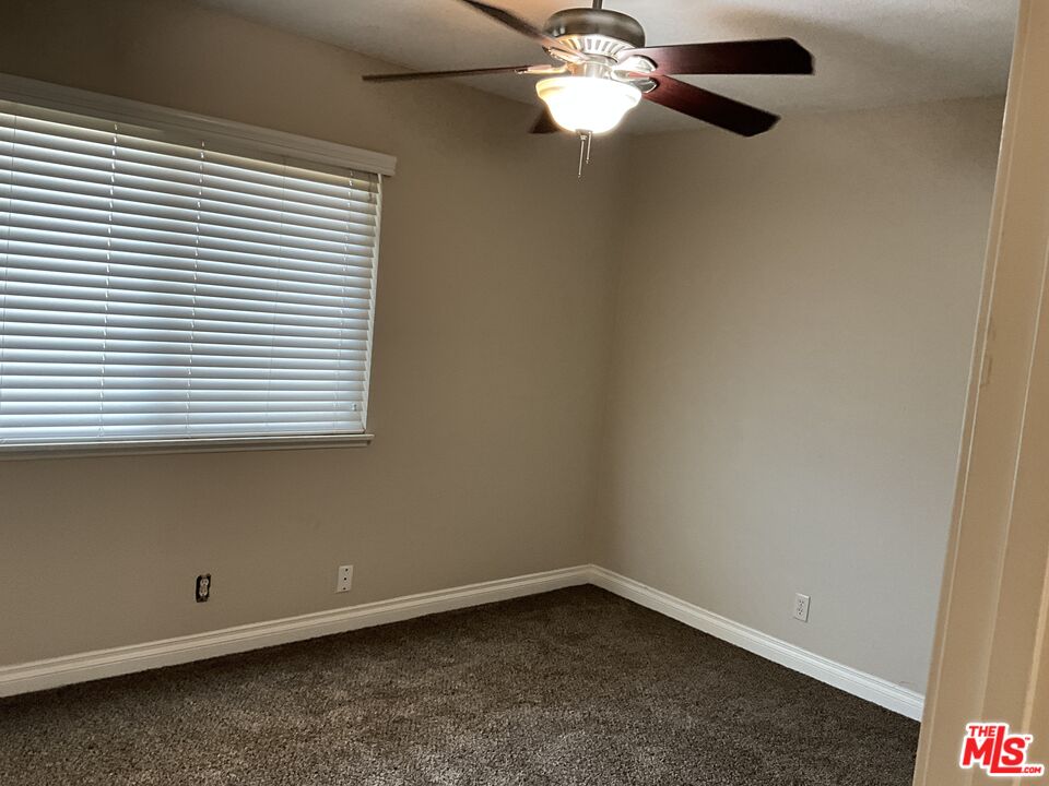 19125 Ottawa Road Apple Valley, CA 92308 - Photo 13 of 15 an empty room with a chandelier fan