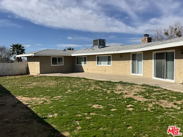 a view of a house with a yard and lake view