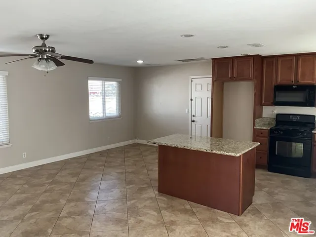 a kitchen with kitchen island cabinets and window