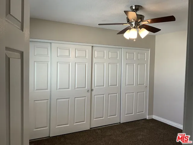 an empty room with a ceiling fan