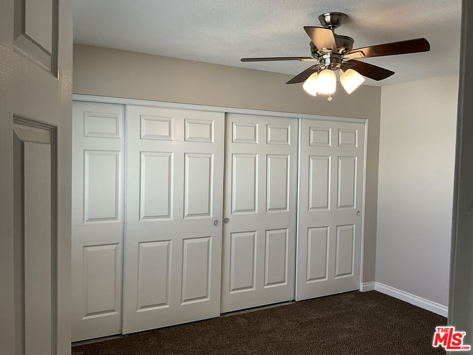 19125 Ottawa Road Apple Valley, CA 92308 - Photo 8 of 15 an empty room with a ceiling fan