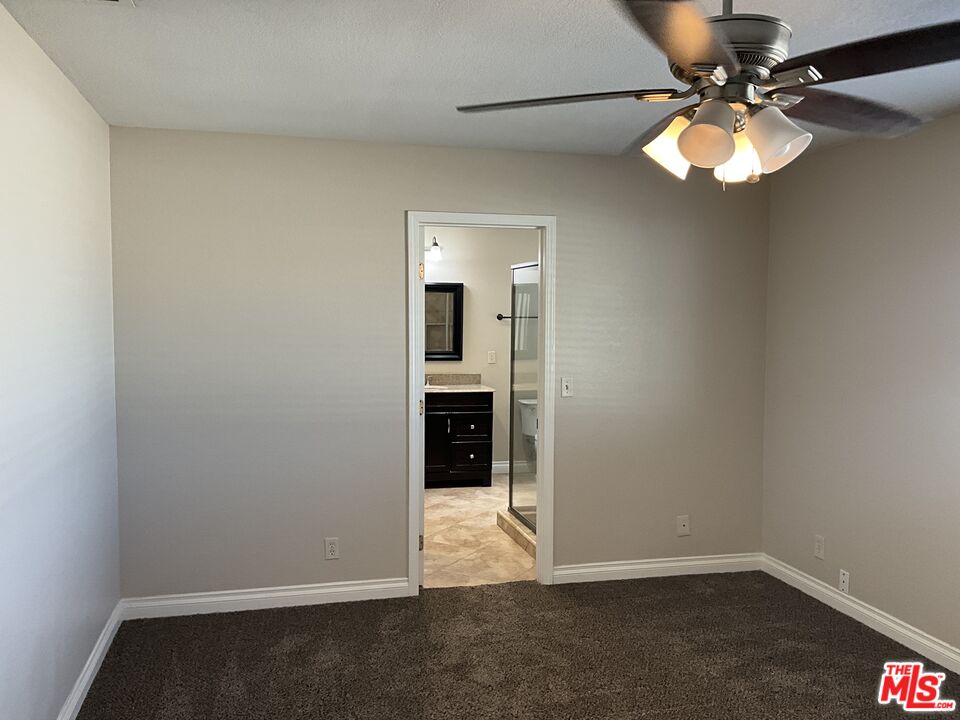 19125 Ottawa Road Apple Valley, CA 92308 - Photo 10 of 15 a view of a livingroom with a chandelier fan and wooden floor