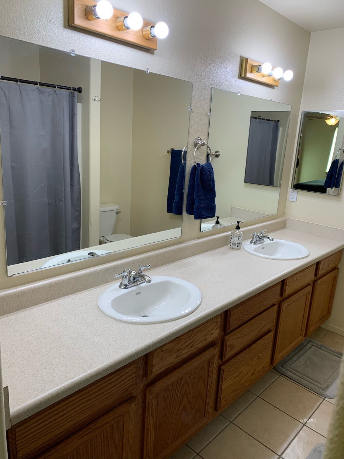 1640 South Mahan Street Ridgecrest, CA 93555 - Photo 21 of 27 a bathroom with a sink and a mirror