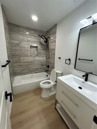 a bathroom with a sink a toilet and a bathtub