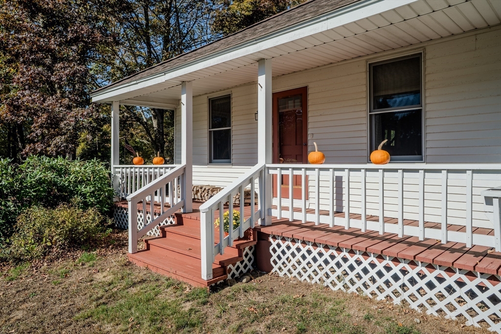 200 Long Plain Road Leverett, MA 01054 - Photo 2 of 40 a porch with a bench next to a yard