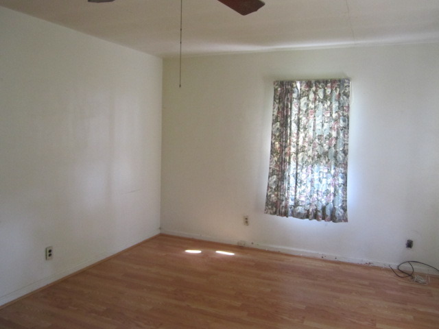 1443 North 32nd Road Ottawa, IL 61350 - Photo 3 of 11 a view of an empty room with wooden floor and a window