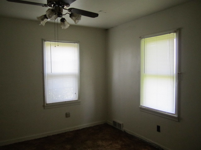1443 North 32nd Road Ottawa, IL 61350 - Photo 6 of 11 an empty room with a window and a fan