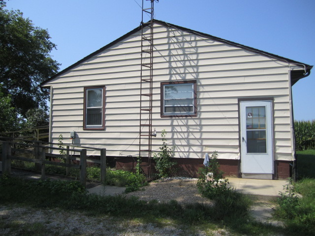 1443 North 32nd Road Ottawa, IL 61350 - Photo 8 of 11 a view of a white house with many windows