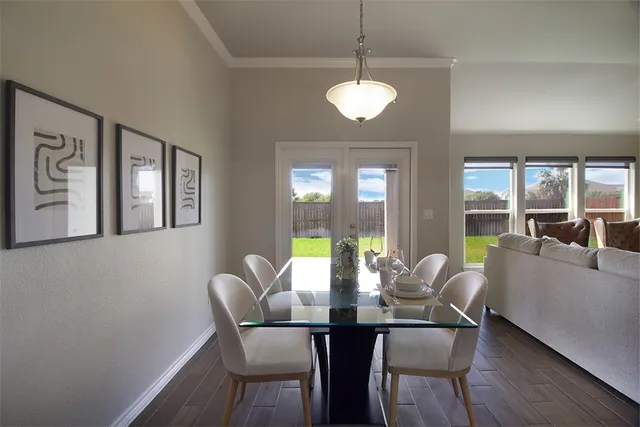 a view of a dining room with furniture wooden floor and chandelier