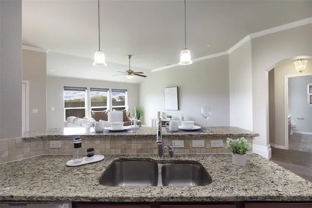 a kitchen with granite countertop a sink and a counter top space