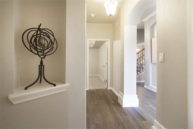 a view of a hallway with wooden floor