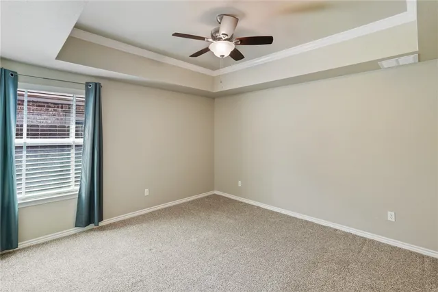 a view of a livingroom with a ceiling fan and window