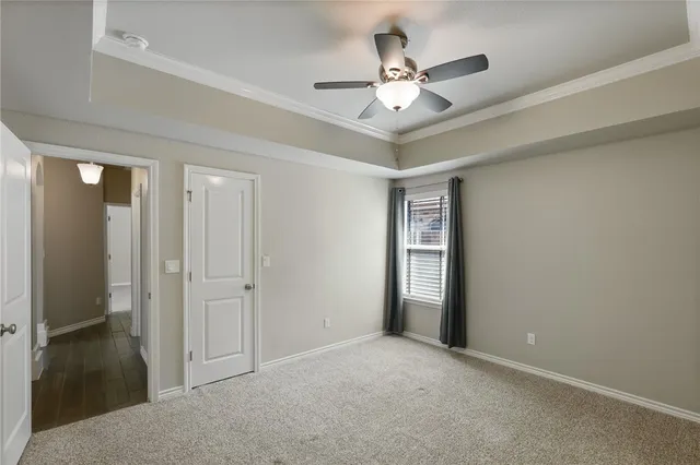 a view of an empty room with a ceiling fan