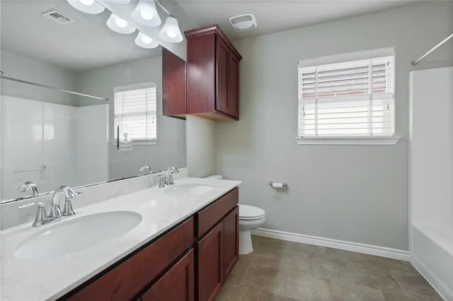 a bathroom with a sink a vanity and a large mirror