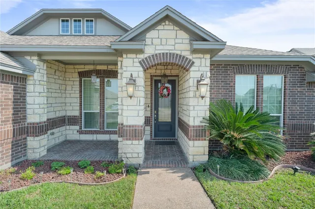 a front view of a house with a garden