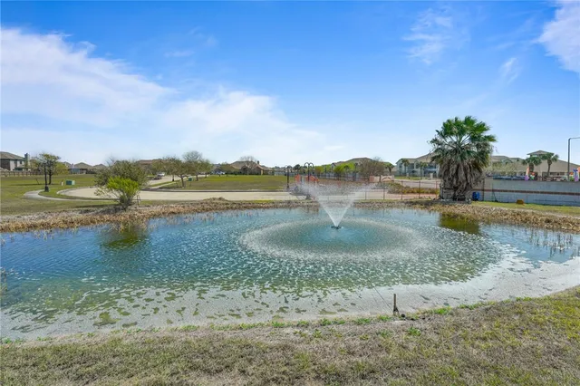 a view of a lake with houses in the background