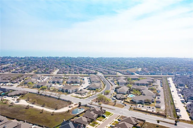 an aerial view of residential building and ocean view