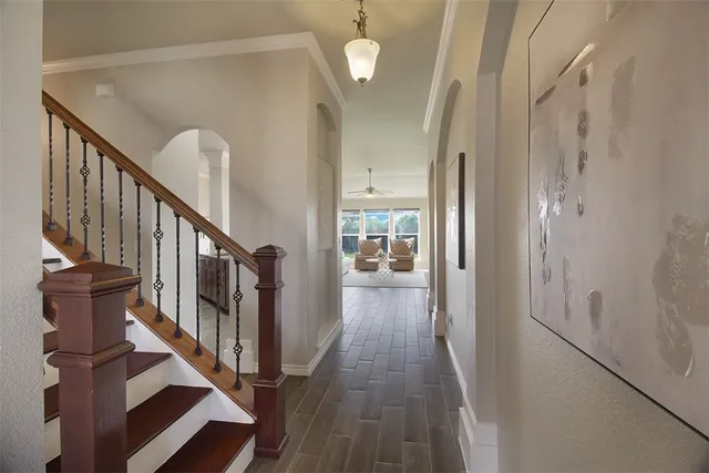 a view of a hallway with wooden floor and entryway