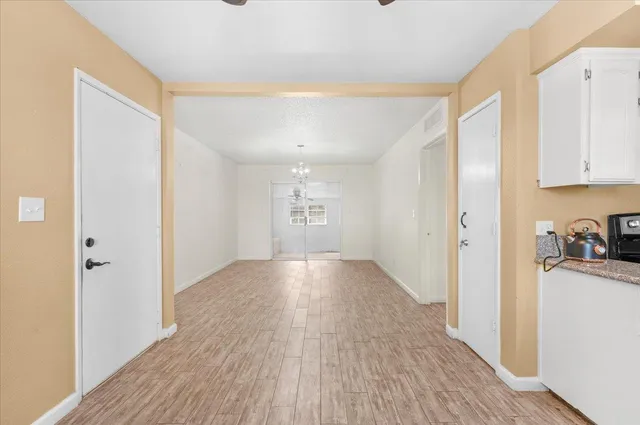 a view of a kitchen with wooden floor and a sink