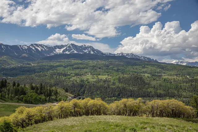a view of a town with mountains in the background