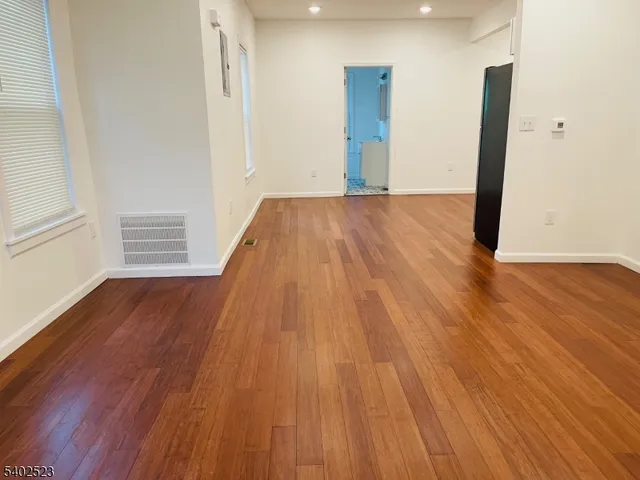 a view of a room with wooden floor and stairs