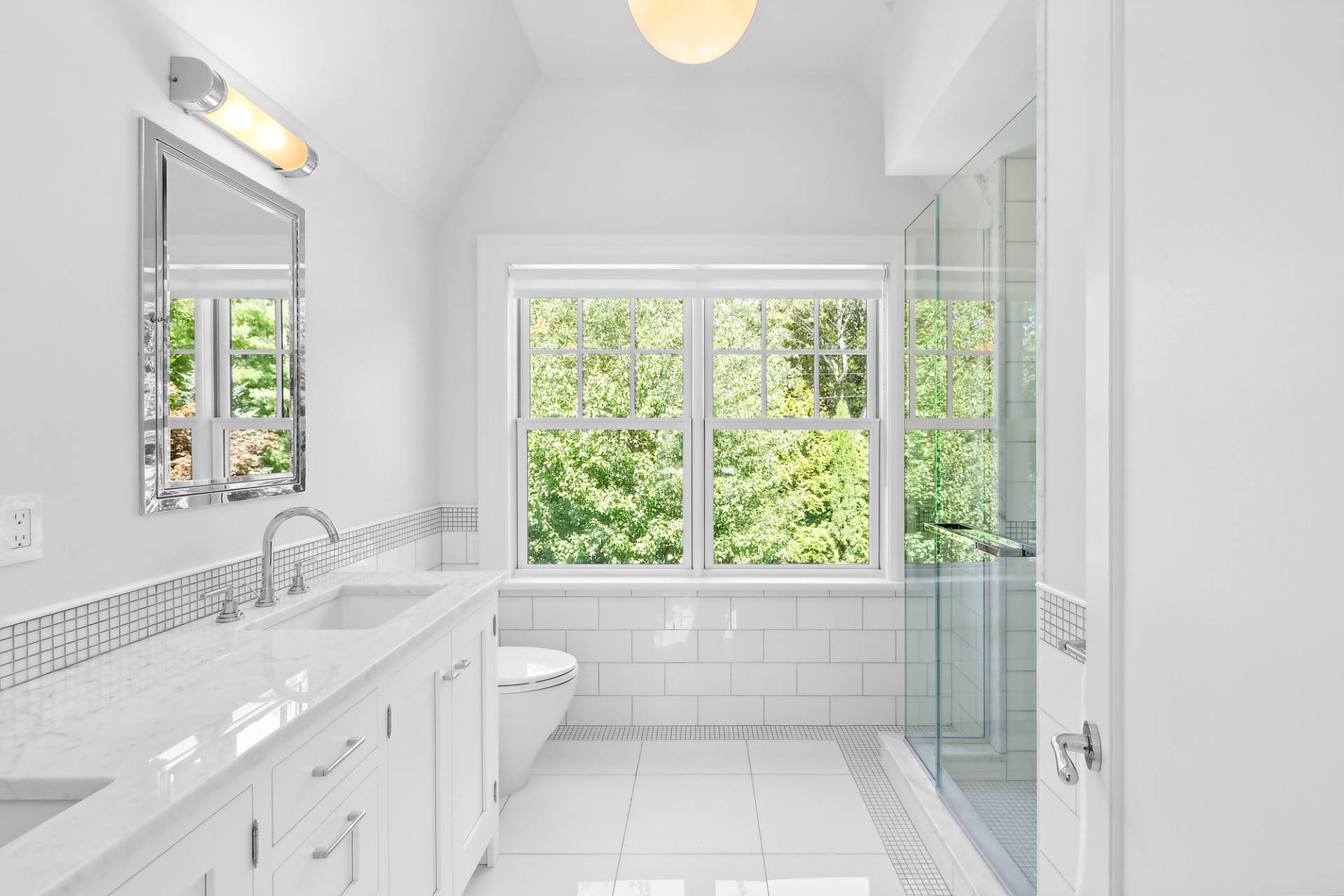 40 Roxbury Lane Wainscott, NY 11975 - Photo 17 of 29 a bathroom with a granite countertop sink a toilet and a window