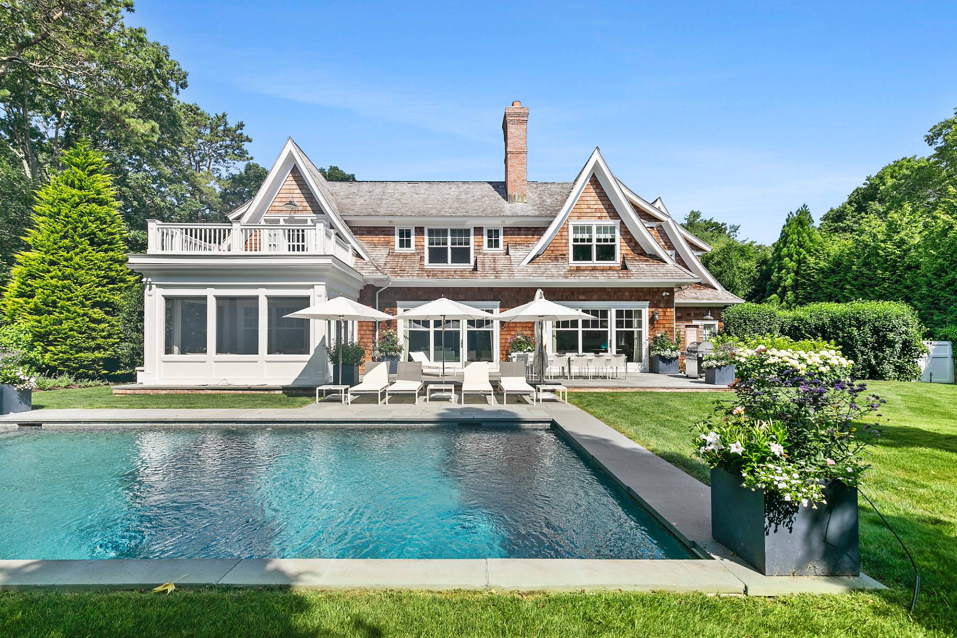 40 Roxbury Lane Wainscott, NY 11975 - Photo 24 of 29 a front view of a house with swimming pool having outdoor seating