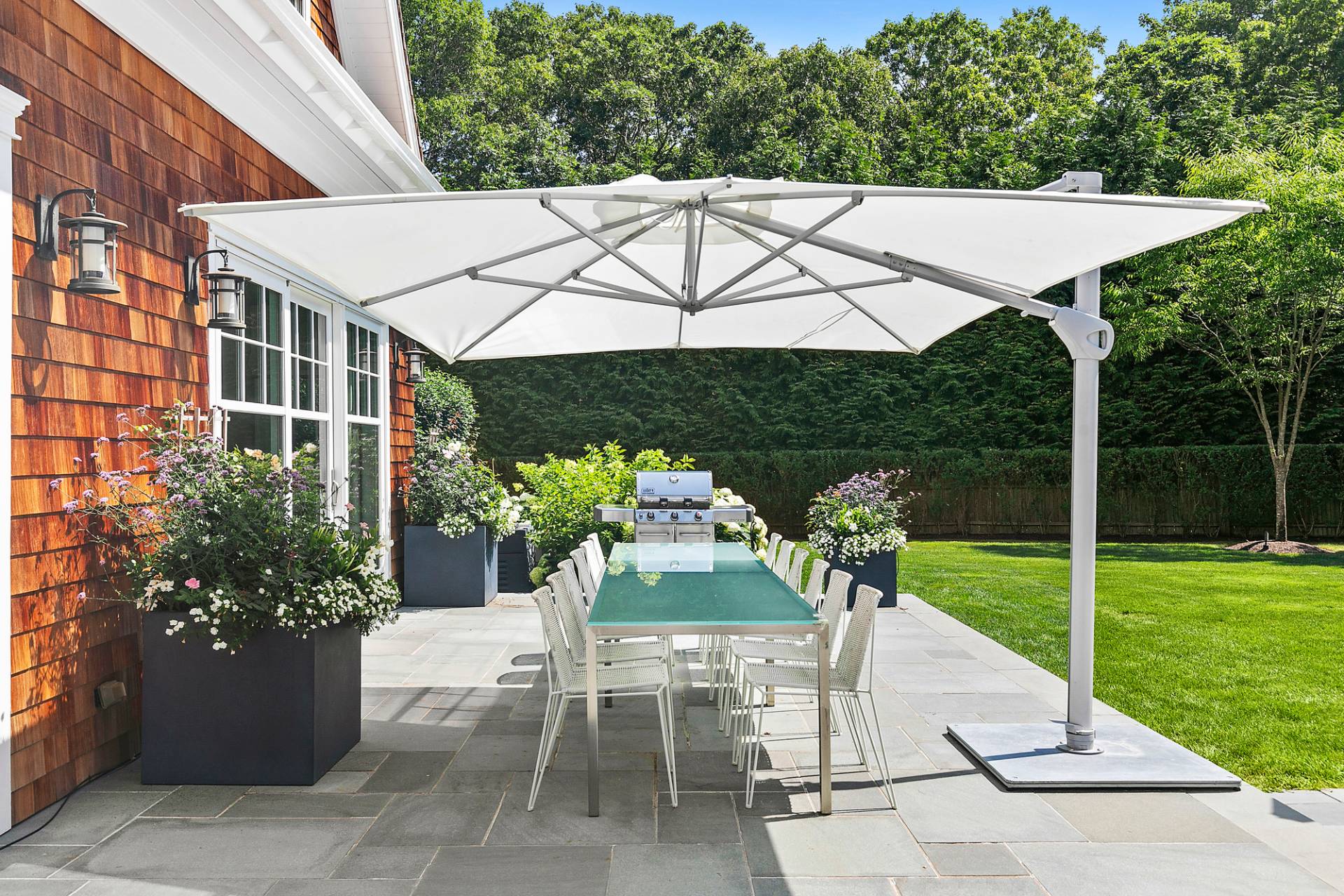 40 Roxbury Lane Wainscott, NY 11975 - Photo 28 of 29 a patio with a yard table and chairs