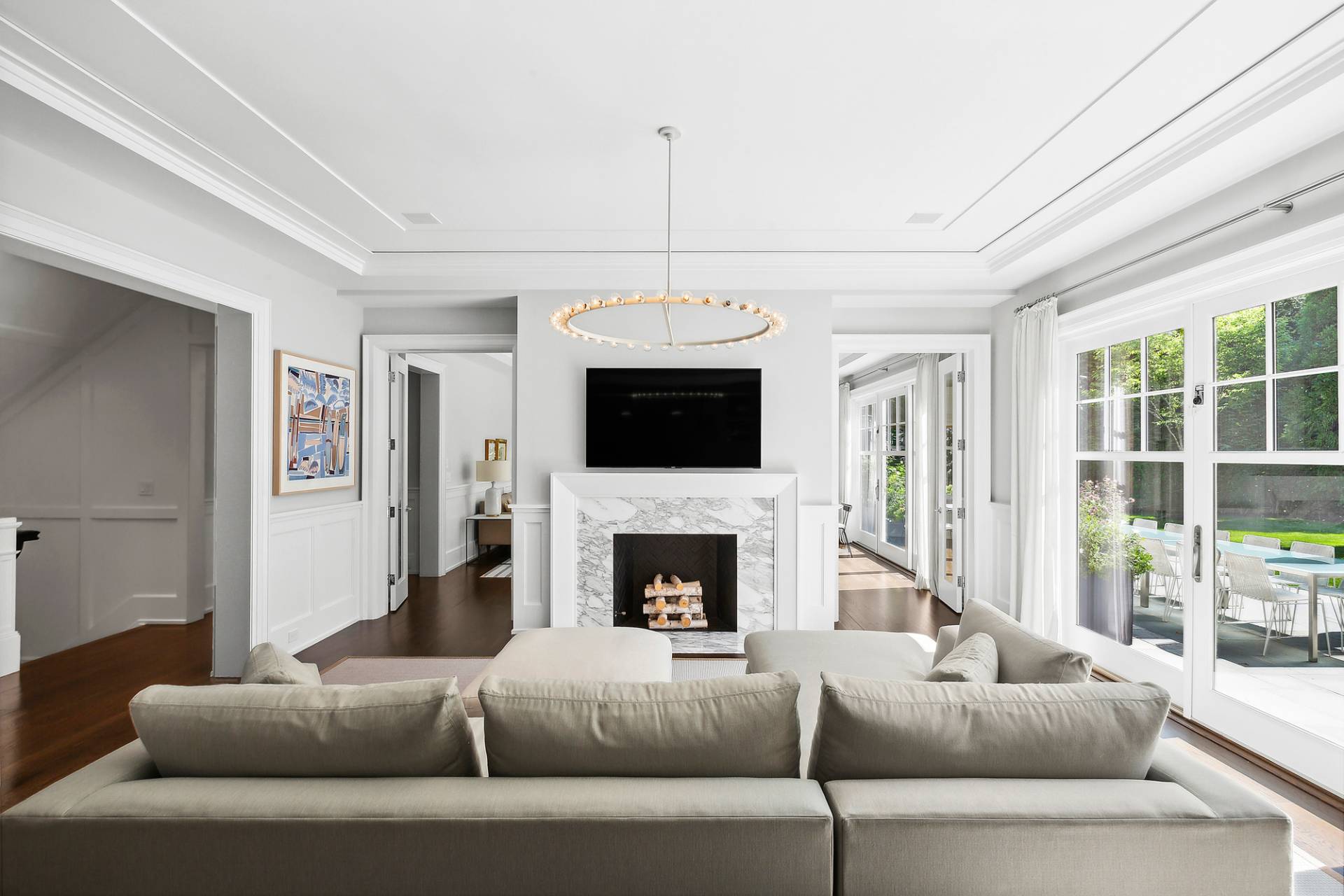 40 Roxbury Lane Wainscott, NY 11975 - Photo 5 of 29 a living room with furniture a flat screen tv and a fireplace