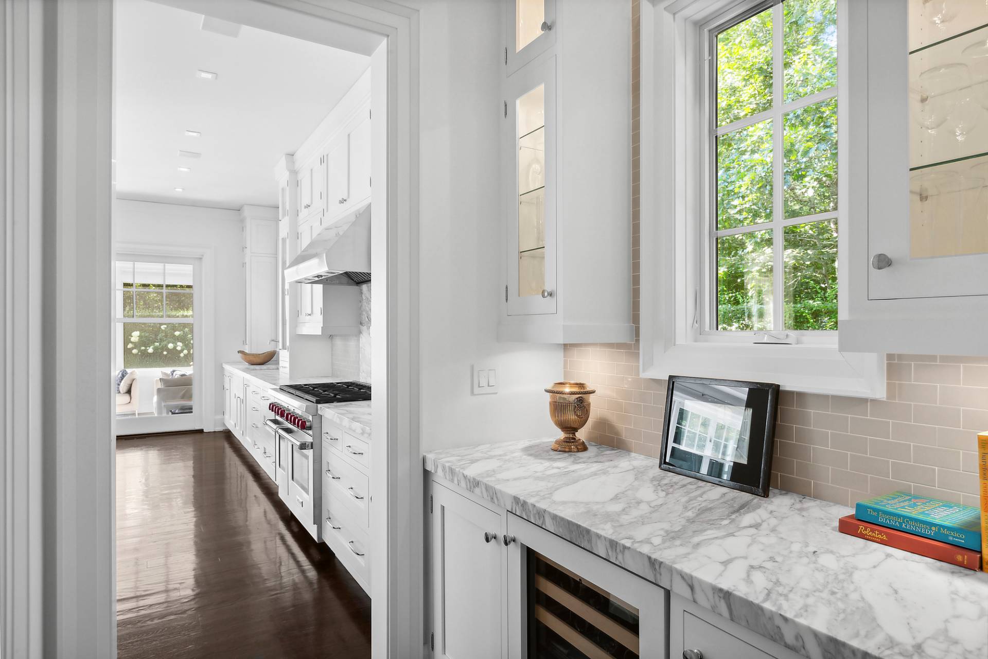 40 Roxbury Lane Wainscott, NY 11975 - Photo 8 of 29 a kitchen with granite countertop a stove a sink a refrigerator wooden floor and cabinets