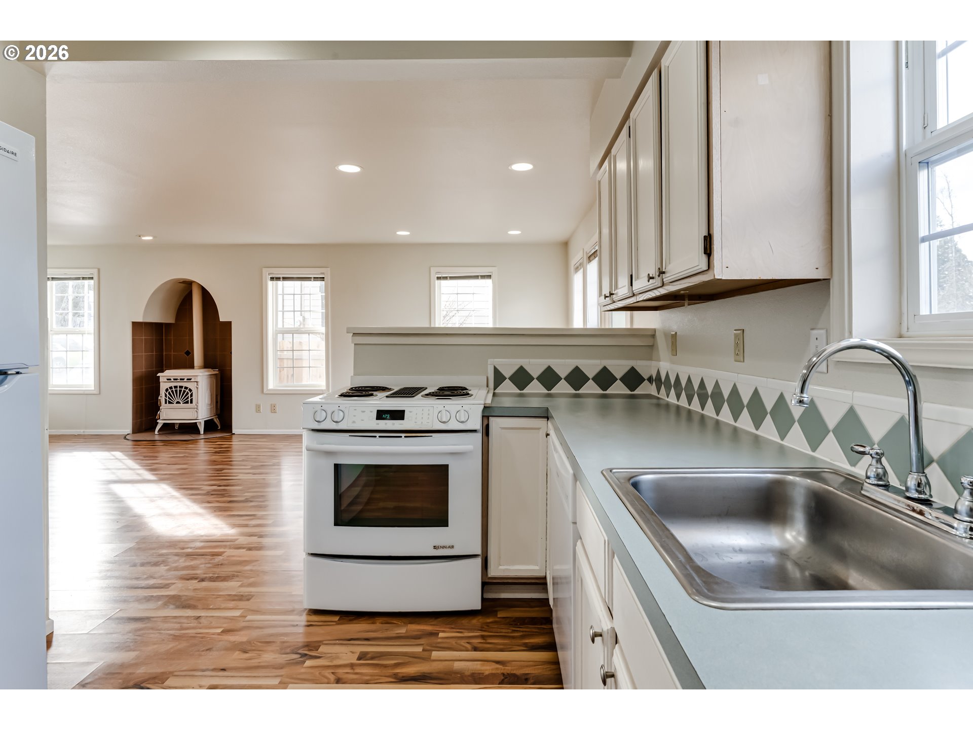 951 West 27th Avenue Eugene, OR 97405 - Photo 13 of 34 a kitchen with a sink cabinets and stainless steel appliances