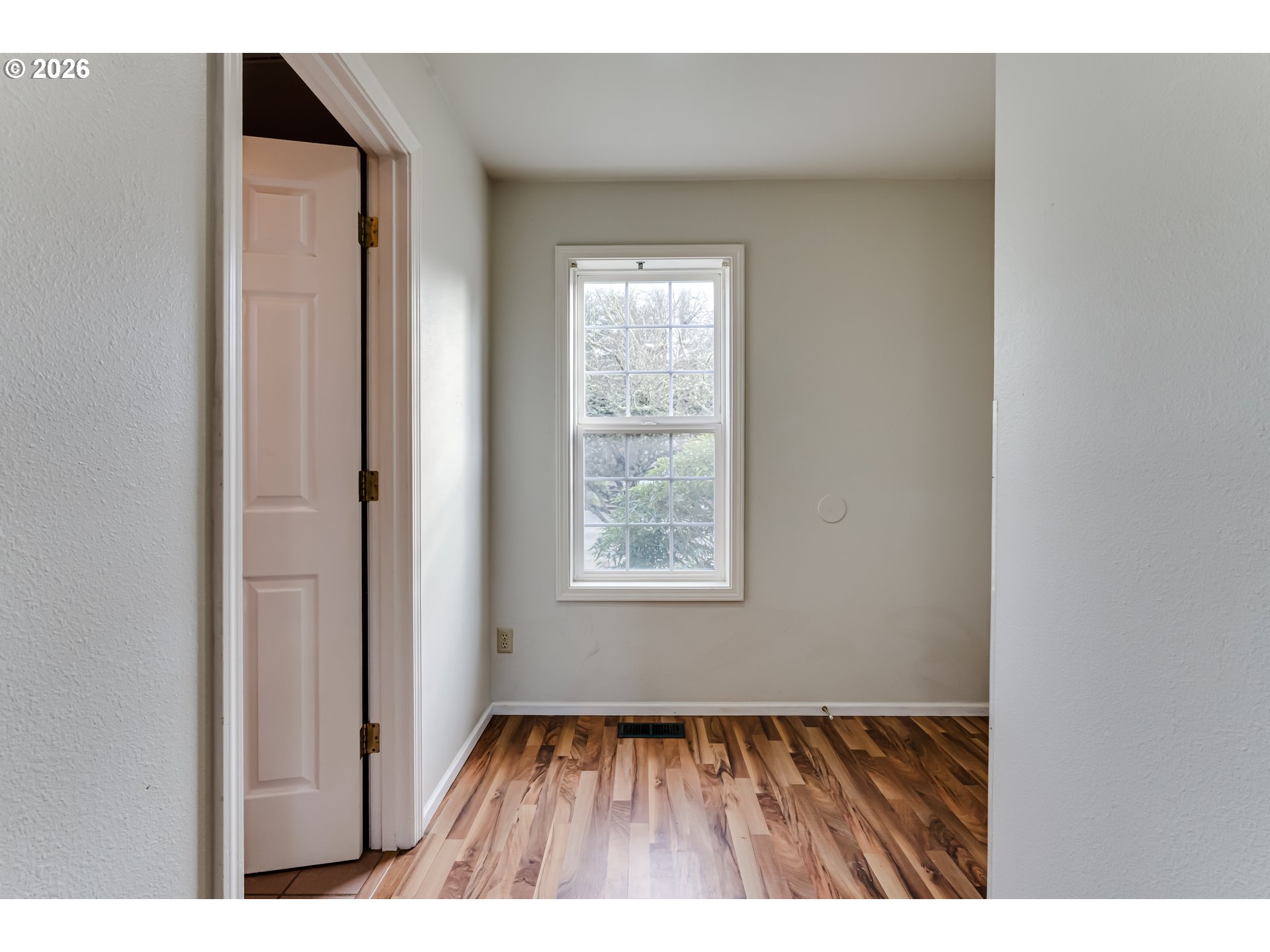 951 West 27th Avenue Eugene, OR 97405 - Photo 16 of 34 a view of an empty room with wooden floor and a window
