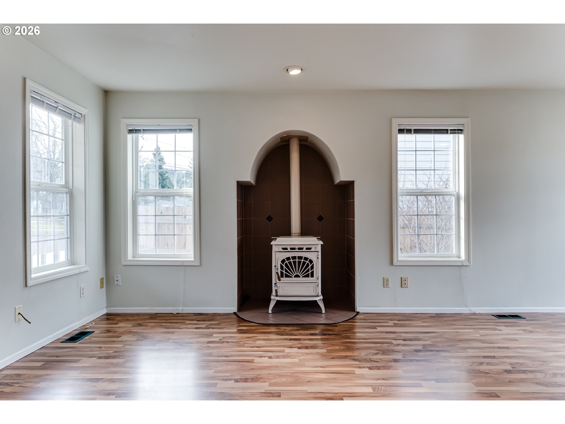 951 West 27th Avenue Eugene, OR 97405 - Photo 8 of 34 a view of an empty room with wooden floor and a window