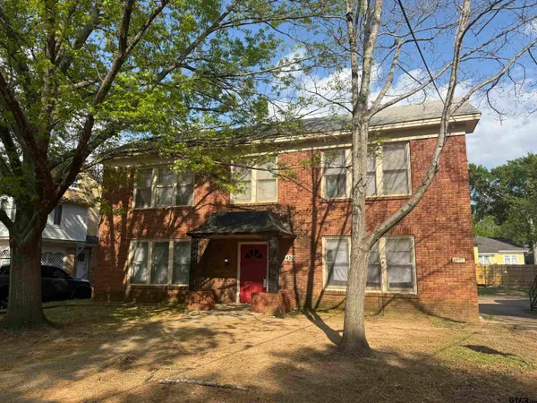 a view of a house with large trees