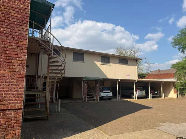 a front view of a house with parking space and garage