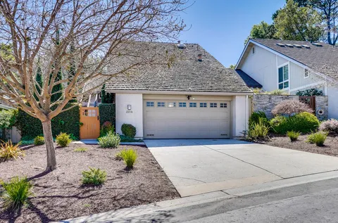 a front view of a house with a yard garage and outdoor seating