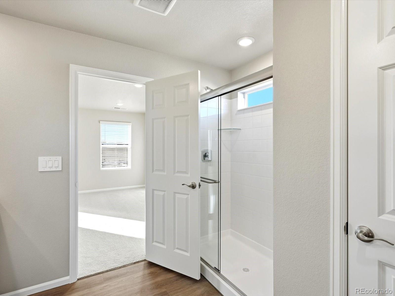 7317 West 27th St Road Greeley, CO 80634 - Photo 23 of 28 a bathroom with a glass shower door