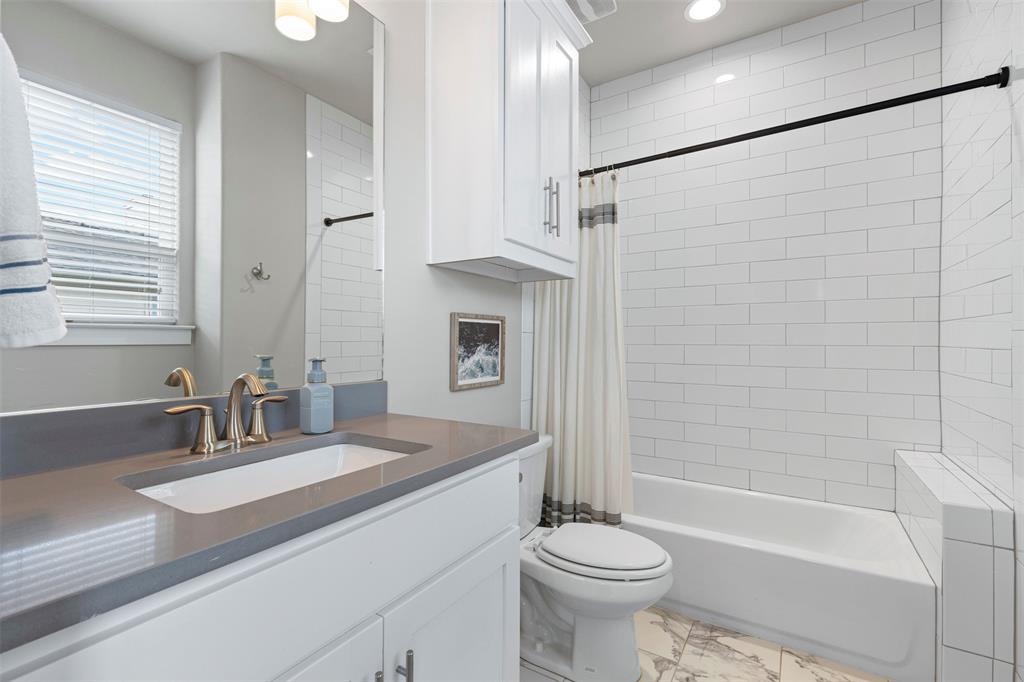 4906 Live Oak Street, Unit 7 Dallas, TX 75206 - Photo 11 of 19 a bathroom with a sink a toilet and shower