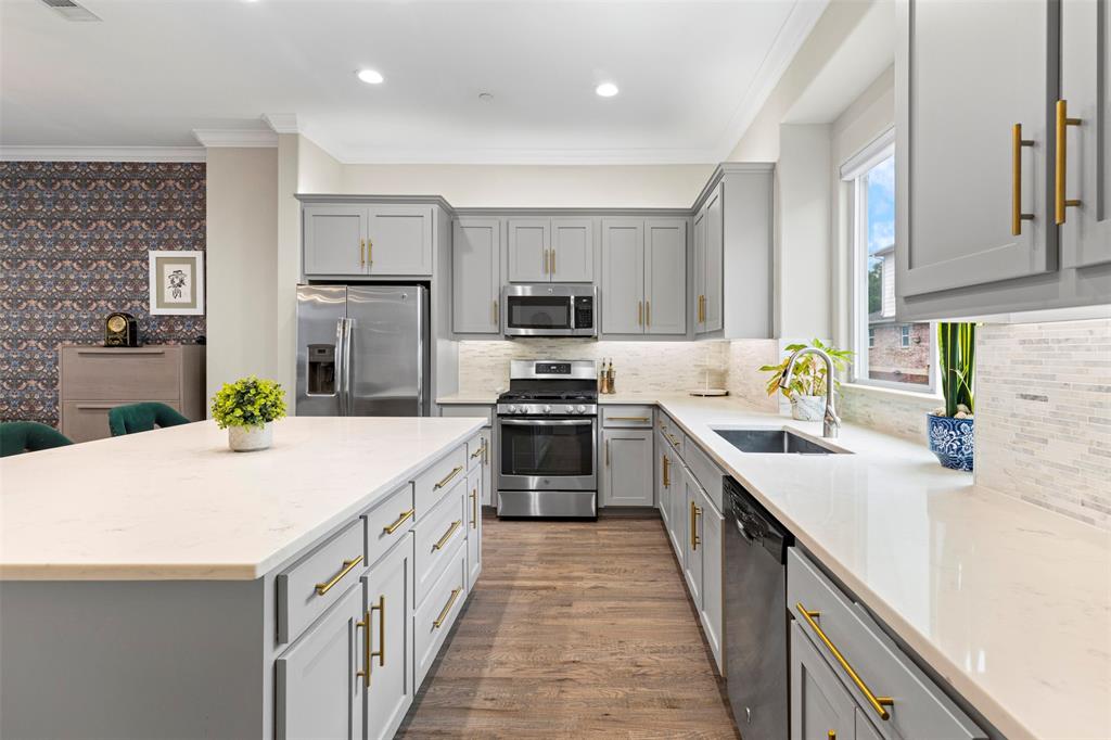4906 Live Oak Street, Unit 7 Dallas, TX 75206 - Photo 3 of 19 a kitchen with kitchen island a stove a sink and a refrigerator