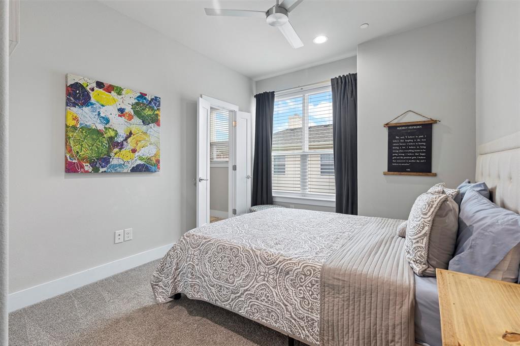4906 Live Oak Street, Unit 7 Dallas, TX 75206 - Photo 10 of 19 a bedroom with a bed painting on wall and a large window