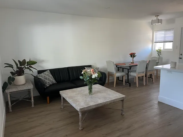 a living room with furniture a window and a table