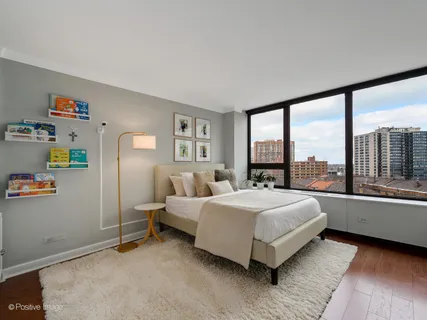 a spacious bedroom with a bed and a large window