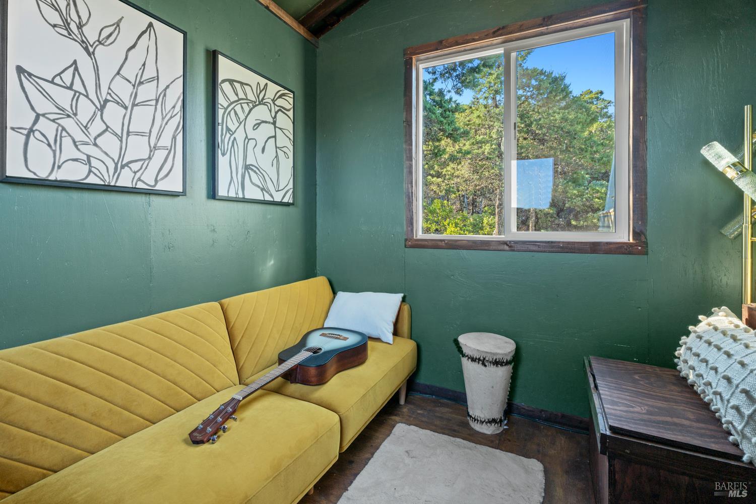 6775 County Road 110 Hopland, CA 95449 - Photo 18 of 53 a blue room with a chair and a potted plant